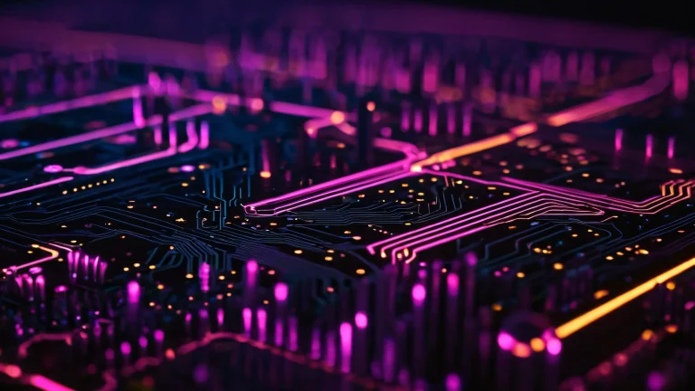 Neon circuit boards with metallic sheen and LED glow on a dark background.