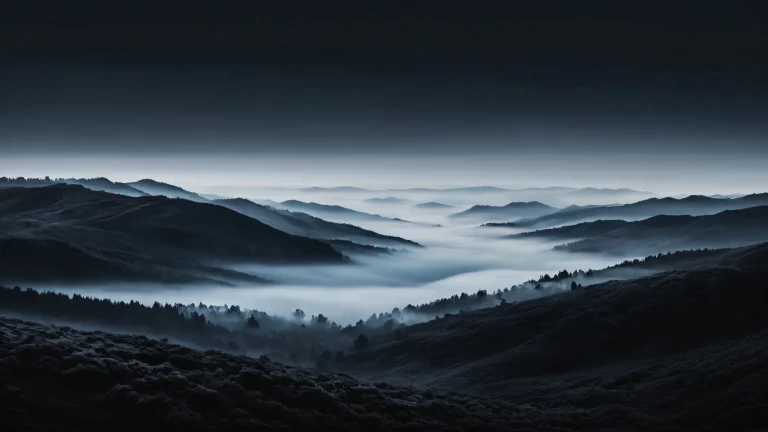 Foggy landscape desktop wallpaper featuring deep perfect blacks and luminescent accents for a sleek dark mode aesthetic, suitable for macOS desktop use.